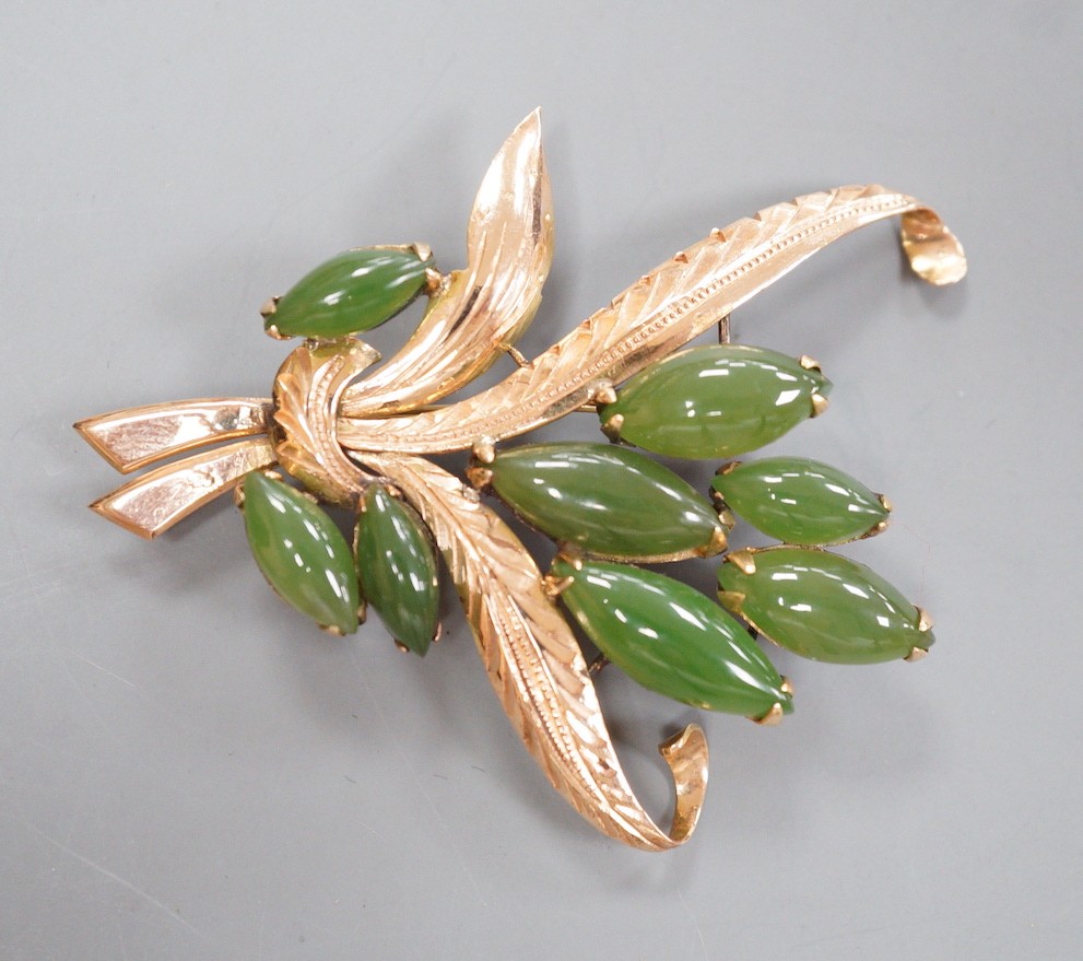 An 18k yellow metal and eight stone cabochon jade set floral spray brooch, 57mm, gross weight 11.1 grams.